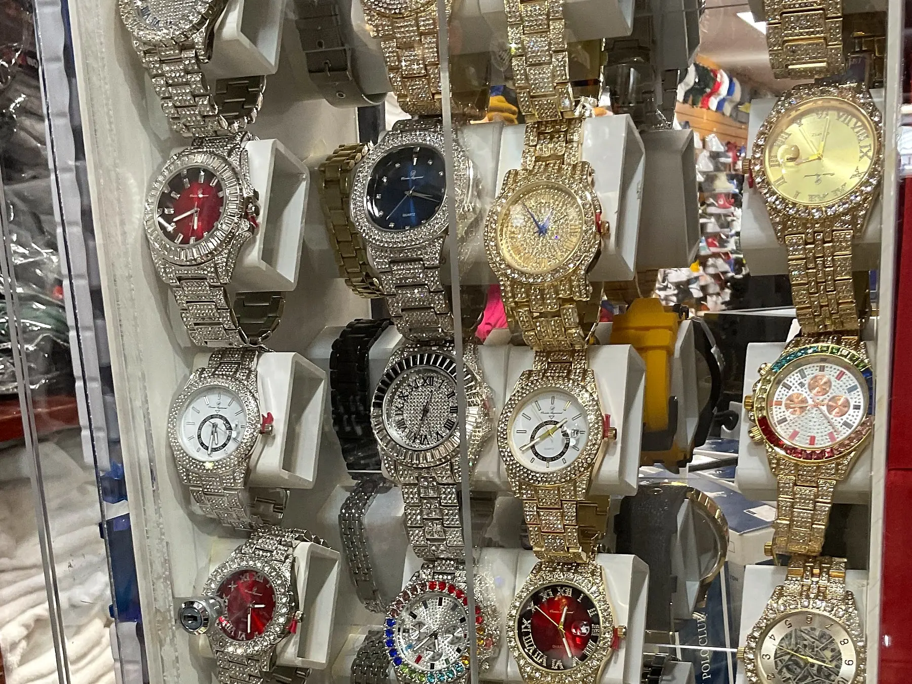Iced-out watches in a display case